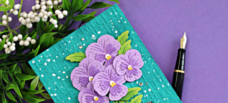 Fresh Packed floral card featuring die cut pansy flowers in a pot, embossed Market Weave background, and ink splatter using Spellbinders Small Die of the Month
