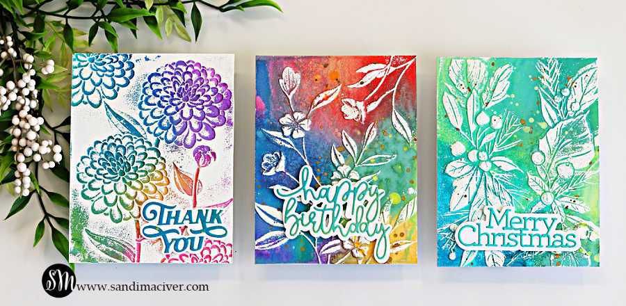 Three handmade cards created with an embossing folder technique for cardmaking, featuring Distress Oxide ink backgrounds and white heat embossed floral designs with “Thank You,” “Happy Birthday,” and “Merry Christmas” sentiments.