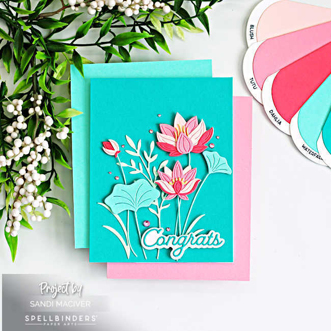 Lotus flower card in pink and teal with layered die cut flowers, leafy stems, and “congrats” sentiment on a blended teal background, handmade cardmaking idea