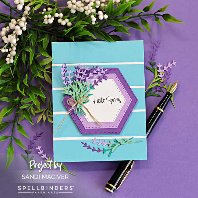 Simple die cut lavender card featuring layered hexagon frames, striped background, and soft purple and green die cut sprigs with Hello Spring sentiment.