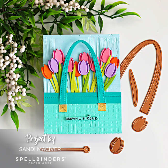 Spring tulip market tote card featuring die cut flowers and embossed background, with Spellbinders tote handle dies displayed alongside the finished handmade card.