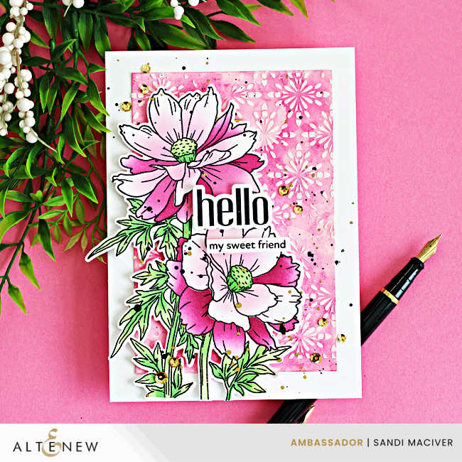 Sulfur Cosmos card close up showing ink blended stenciled flowers layered over a pink ink smooshed background with white texture paste and gold splatter