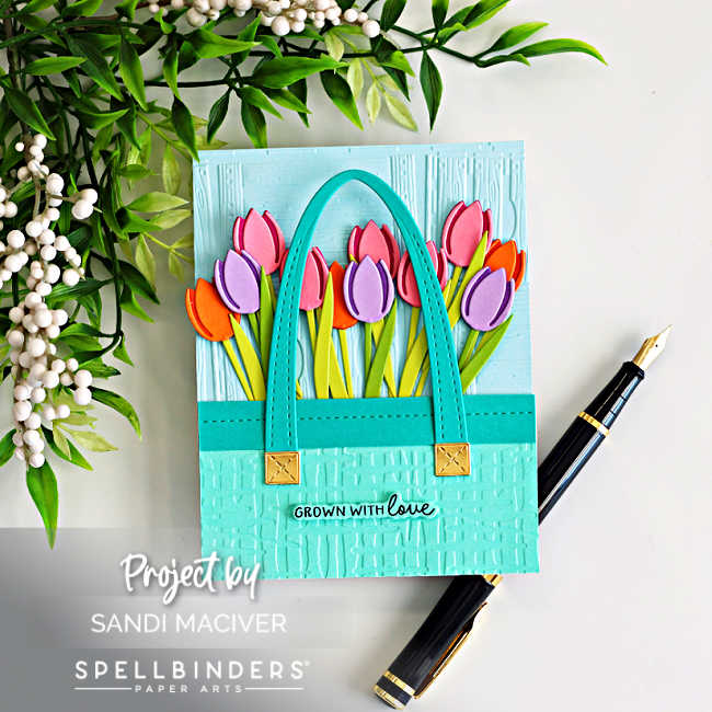 Die cut tulip market tote card with embossed background, featuring colorful layered tulips, stitched tote handles, and “grown with love” sentiment by Spellbinders.