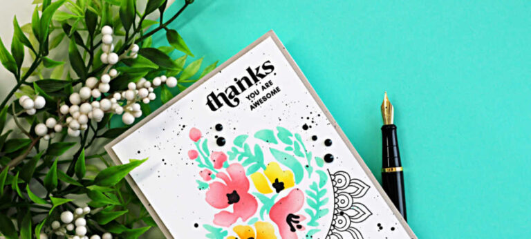 Close-up of a clean and simple floral thank you card featuring soft ink-blended pink and yellow flowers with mint green leaves from the Altenew Dynamic Duo Crescent Flowers stamp and stencil set. The modern card design includes black splatter details, bold sentiment stamping, and an outline arch accent on a white background.