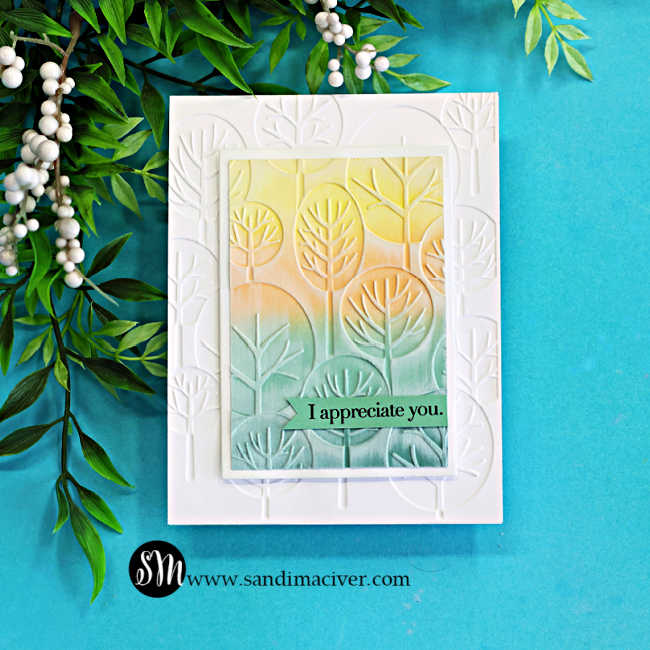 Handmade card with embossing folder background, die cut frame, and soft ink blended panel in yellow and green tones, finished with white ink highlighting and an “I appreciate you” sentiment