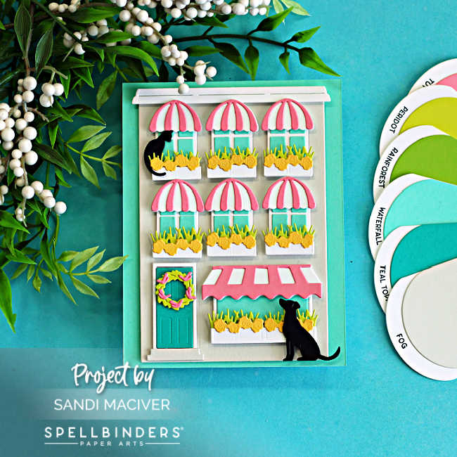 Layered storefront card created with Spellbinders Yana’s Everyday City Holiday dies featuring pink striped awnings, flower-filled window boxes, black cats, and a soft spring color palette of Fog, Teal Topaz, Waterfall, Peridot, Tutu, and black cardstock.