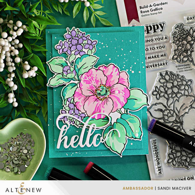 Layered stenciled spring floral card featuring bright pink flowers, lavender blossoms, mint green leaves, white splatter, and a large die cut hello sentiment on a deep teal background using Altenew Rosa Gallica.