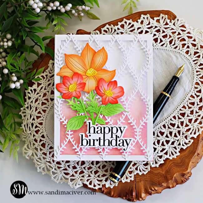 Peek-a-boo see-through floral birthday card featuring Simon Says Stamp Willowweave Plate layered over a soft pink ink blended background with Luna Flower and Sunblush Flowers dies in peach, coral, and green, finished with a bold happy birthday sentiment.