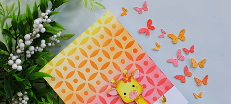Close-up of a handmade giraffe card featuring the Simon Says Stamp Fable Giraffe Die on a warm yellow, orange, and pink ink-blended Dot Petal Pattern stenciled background, surrounded by tiny butterfly die cuts.