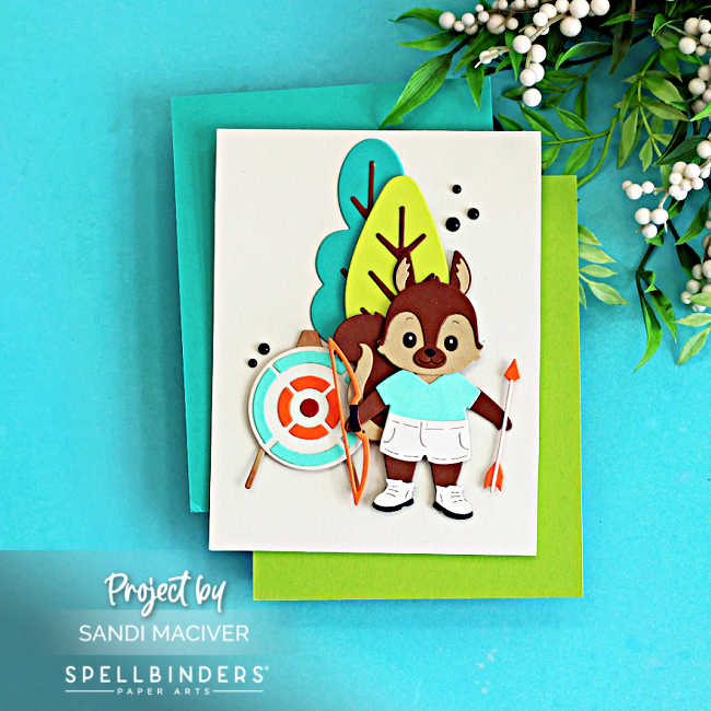 Cute summer camp die cut card featuring a layered squirrel archer with a bow, arrow, and target, created with the Spellbinders Summer Camp Collection by Alli Fraser using teal, green, orange, brown, and white cardstock.