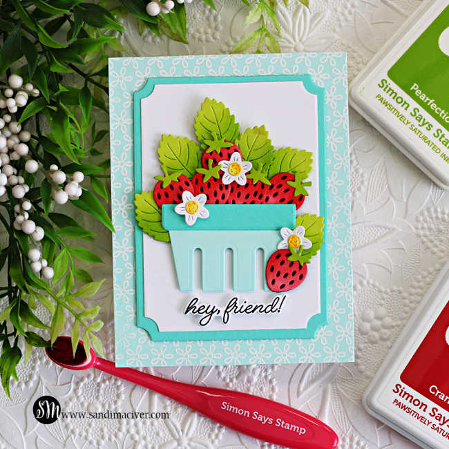Handmade strawberry basket friendship card featuring layered die cut strawberries, ink blended green leaves, and tiny white flowers arranged inside a soft aqua basket. The background features the Petite Petal Background stamp white heat embossed onto Seaside cardstock with layered A2 Notched Rectangle frames and a “hey friend!” sentiment.