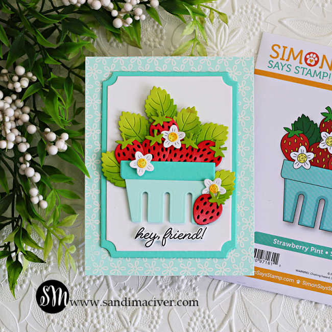 Handmade strawberry basket friendship card featuring layered die cut strawberries, ink blended green leaves, and tiny white flowers arranged inside a soft aqua basket. The background features the Petite Petal Background stamp white heat embossed onto Seaside cardstock with layered A2 Notched Rectangle frames and a “hey friend!” sentiment.