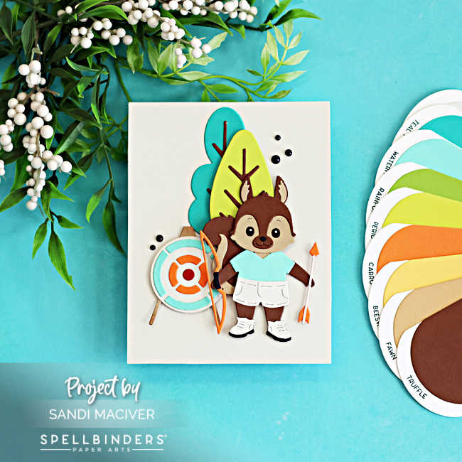Cute summer camp die cut card featuring a layered squirrel archer with a bow, arrow, and target, created with the Spellbinders Summer Camp Collection by Alli Fraser using teal, green, orange, brown, and white cardstock.