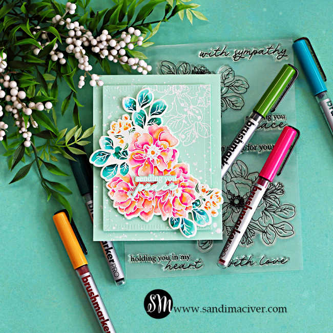 Handmade floral sympathy card created with watercoloring using Karin Markers, featuring bright pink and coral Wild Rose flowers, teal leaves, layered mint cardstock, and white splatter details surrounded by Karin Brushmarker PRO pens on an aqua background.