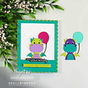 Handmade birthday card featuring the Spellbinders Party Time Dragon peeking through a teal polaroid-style frame. The lime green and lavender dragon holds a bright pink balloon against a white embossed Cloud Nine background. A coordinating purple and teal dragon with a mint balloon is displayed beside the card, while leafy greenery with white berries accents the scene. The cheerful design includes layered die cuts, dimension, and birthday sentiments.