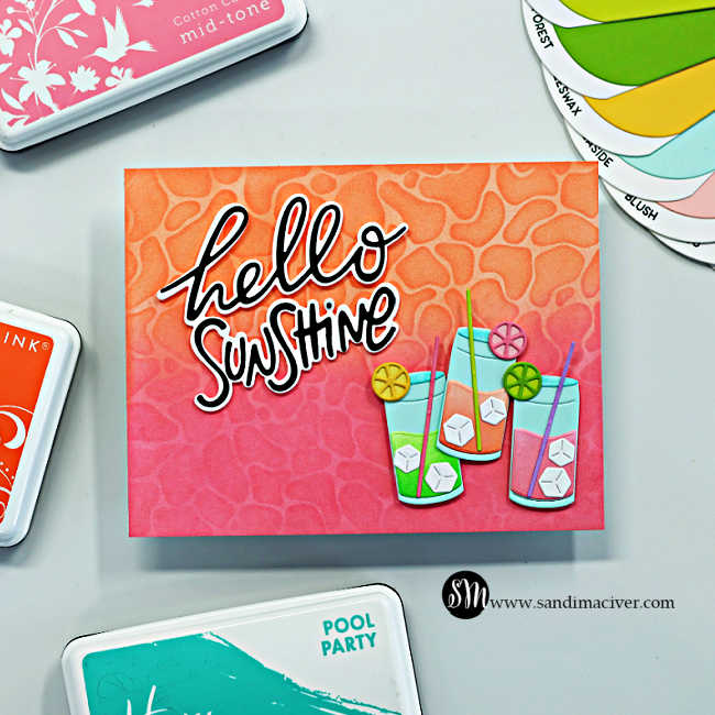 Bright summer-themed handmade card featuring a pink and orange ink-blended background with a layered water ripple stencil design. The card is decorated with colorful tropical drink die cuts, citrus slice accents, ice cubes, and a bold black and white “hello sunshine” sentiment. Coordinating cardstock swatches and Hero Arts ink pads frame the card for a bright tropical summer feel.