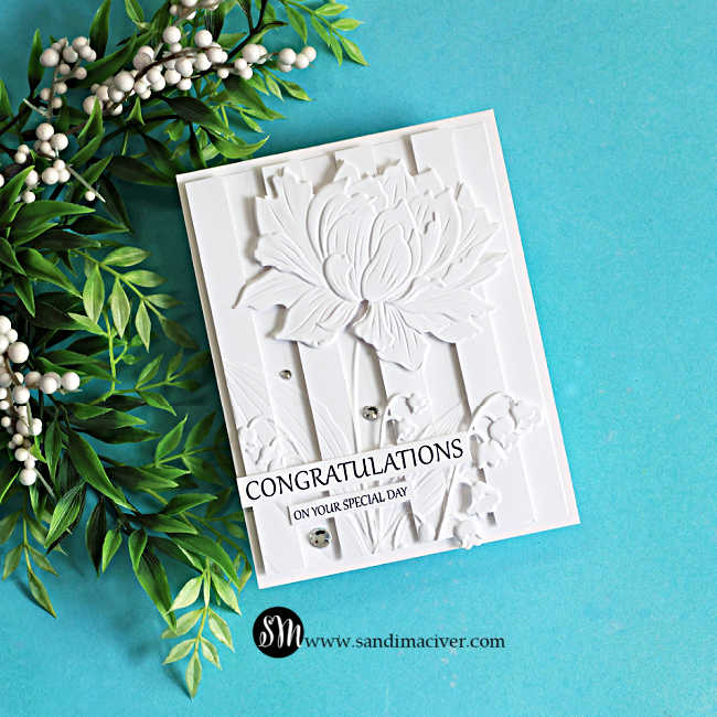 Elegant white-on-white embossed congratulations card featuring the Embossed Double Vision technique. A large layered flower and delicate floral accents are raised over dimensional vertical panels, creating rich texture and depth with a clean monochromatic design.