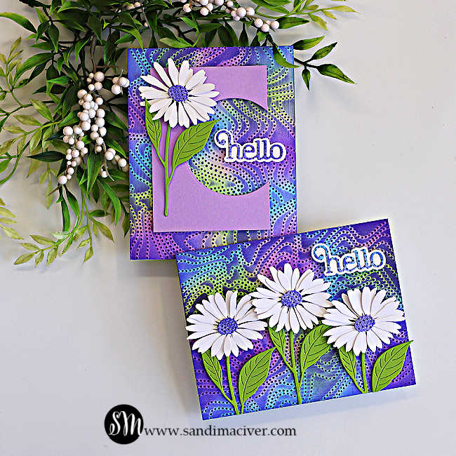 Two handmade greeting cards featuring the Embossed Joseph's Coat technique with the Dotty Contour Embossing Folder. Vibrant embossed backgrounds in shades of purple, blue, and lime green are paired with white daisy die cuts, green leaves, and layered "hello" sentiments. One card features a lavender die-cut panel with a curved peek-a-boo window that frames the "hello" sentiment, while the other showcases three daisies across the front.