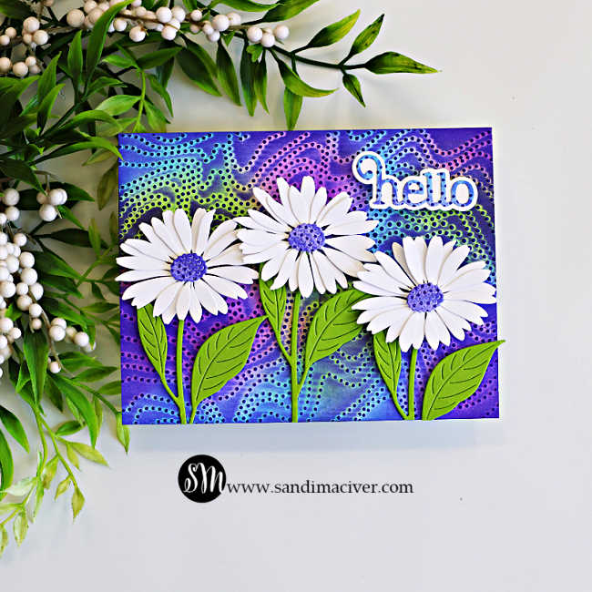 Handmade greeting card featuring the Embossed Joseph's Coat technique with the Dotty Contour Embossing Folder. A vibrant embossed background in shades of purple, blue, and lime green is accented with three layered white daisies, bright green leaves, and a layered "hello" sentiment in the upper right corner.