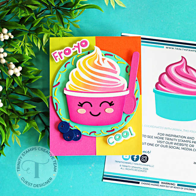 Handmade summer card featuring a smiling frozen yogurt cup from the Trinity Stamps Fro-Yo Friends release. The fro-yo is blended in soft pink, yellow, and orange shades and paired with a bright pink spoon. It sits on a colorful color-blocked background of pink, yellow, orange, and aqua cardstock, framed by a sprinkle-covered circle. Blueberry embellishments and playful "Fro-Yo" and "Cool" sentiments complete this cheerful card design.