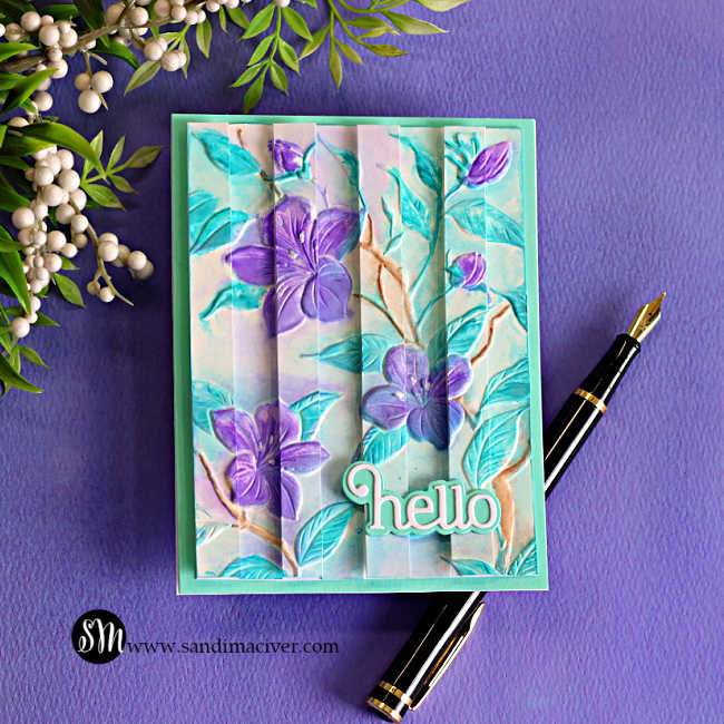 Handmade floral card featuring the Faux Watercolor Embossed Double Vision technique with purple flowers, aqua embossed leaves, dimensional vertical panels, and a layered "hello" sentiment on a turquoise card base.