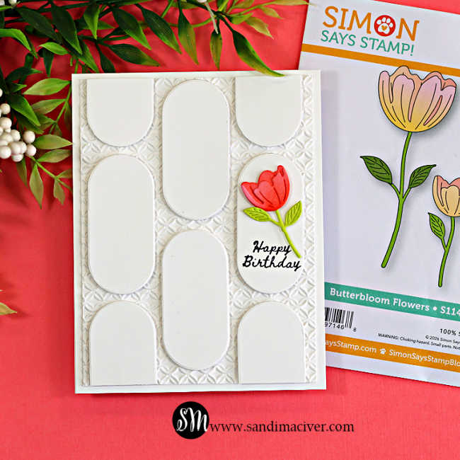 White geometric birthday card created with repeated oval die cuts over an embossed background, accented with a coral tulip and shown beside the Simon Says Stamp Butterbloom Flowers die set.
