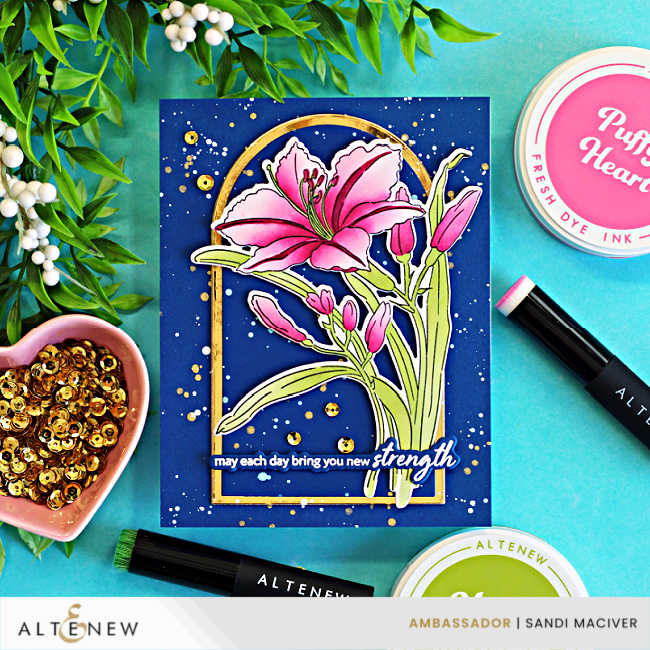 Handmade Dark and Moody floral card featuring the Altenew Leaning Lily stamp, layering stencils, and coordinating die. A vibrant pink lily is showcased inside a gold arched frame on a deep navy background with gold and white splatter, surrounded by Altenew ink pads, blending brushes, and gold sequins.