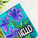Handmade floral card featuring purple Alstroemeria blooms watercolored with Karin Markers on a vibrant teal background, finished with a bold HELLO sentiment.