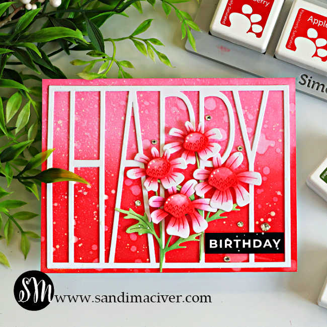 Ink blended happy birthday card featuring the Simon Says Stamp Tall Happy Cover Die over a pink ombré background created with Rhubarb, Apple, and Cranberry Pawsitively Saturated Inks. Layered Quirky Daisies, white paint splatter, Clear Pawsitively Dazzling Gems, and a bold black birthday sentiment complete the design.
