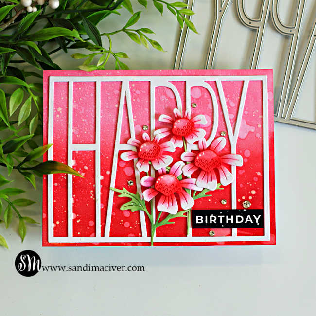 Pink ink blended happy birthday card featuring the Simon Says Stamp Tall Happy Cover Die and layered Quirky Daisies. The background is blended with Rhubarb, Apple, and Cranberry Pawsitively Saturated Inks, accented with water droplets, white paint splatter, Clear Pawsitively Dazzling Gems, and a bold black birthday sentiment.