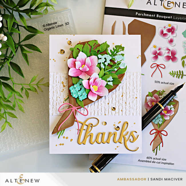 Elegant Parchment Bouquet Thank You Card created with the Altenew Parchment Bouquet Die Set, featuring layered pink flowers, lush green foliage, an embossed Organic Linen background, gold splatter, and a gold "thanks" sentiment, displayed with the coordinating die set packaging and embossing folder.
