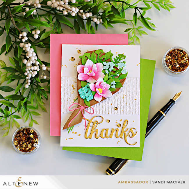 Elegant Parchment Bouquet Thank You Card featuring the Altenew Parchment Bouquet Die Set with layered pink flowers, green foliage, an embossed Organic Linen background, gold splatter, and a gold "thanks" sentiment, displayed on pink and green cardstock with gold sequins and a fountain pen.