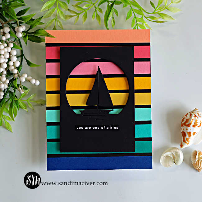 Handmade retro sailboat card featuring colorful horizontal cardstock stripes in coral, pink, yellow, aqua, and navy, with a black sailboat silhouette inside a circular die-cut window. A small "you are one of a kind" sentiment completes this clean and modern masculine card design.