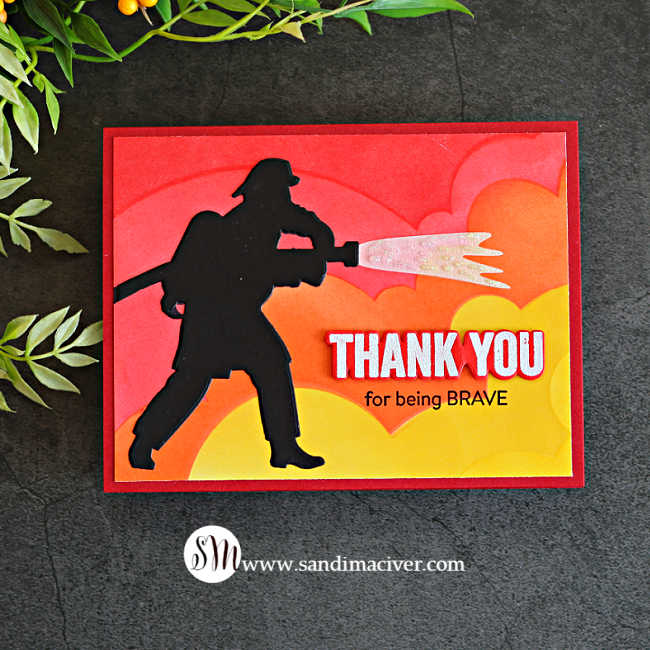Handmade Brave Firefighter thank you card featuring a black firefighter silhouette spraying sparkling water over a layered red, orange and yellow ink-blended background.
