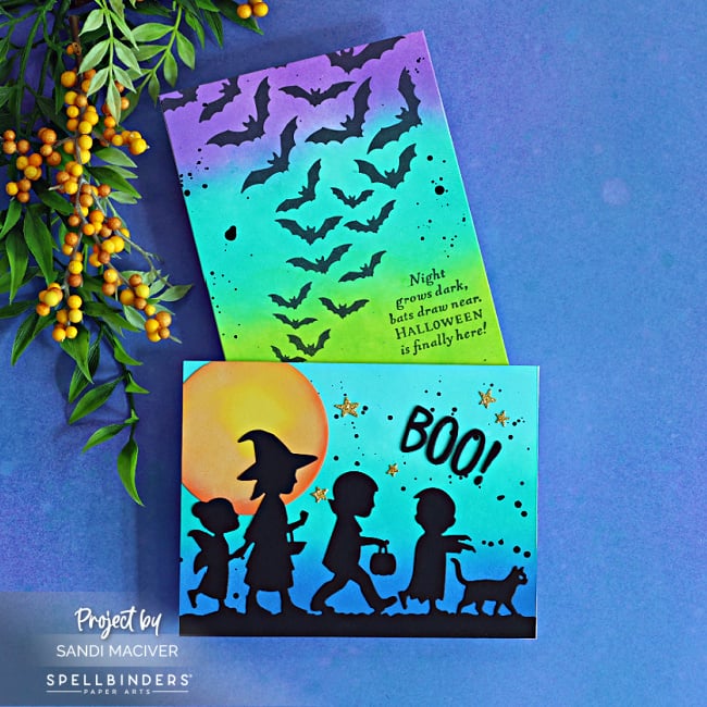 Two colorful Halloween cards featuring black silhouettes over vibrant Distress Oxide ink-blended backgrounds, including trick-or-treaters beneath a glowing moon and a dramatic sky filled with flying bats.