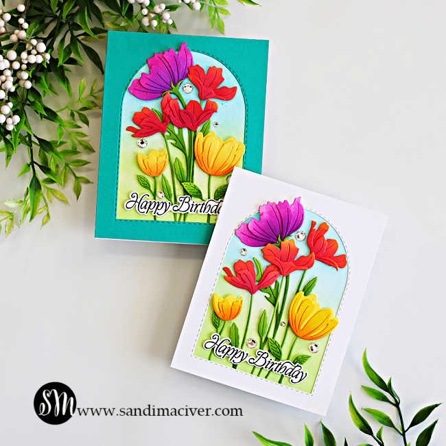 Two colorful floral birthday cards featuring ink-blended die-cut flowers arranged inside stitched arch frames, shown with teal and white backgrounds