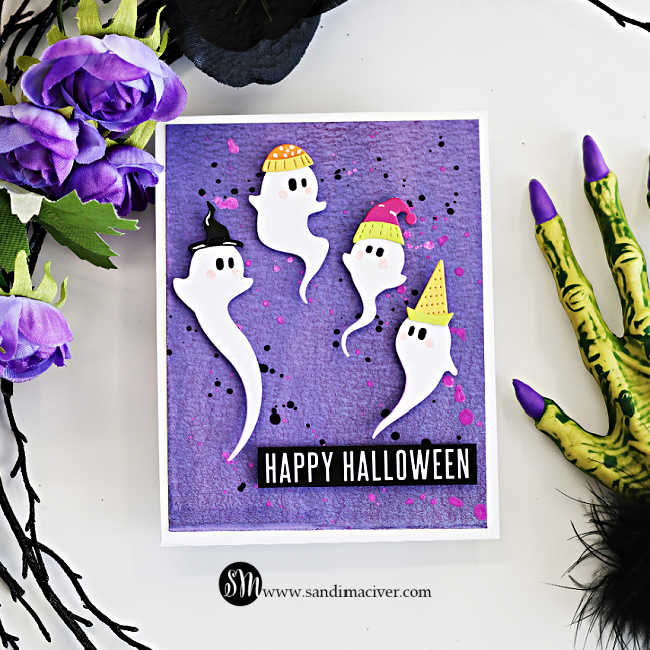 hite Halloween card featuring four adorable swirling ghosts wearing colorful hats on a purple Distress Oxide spray background with black and bright pink splatters, finished with a bold Happy Halloween sentiment.
