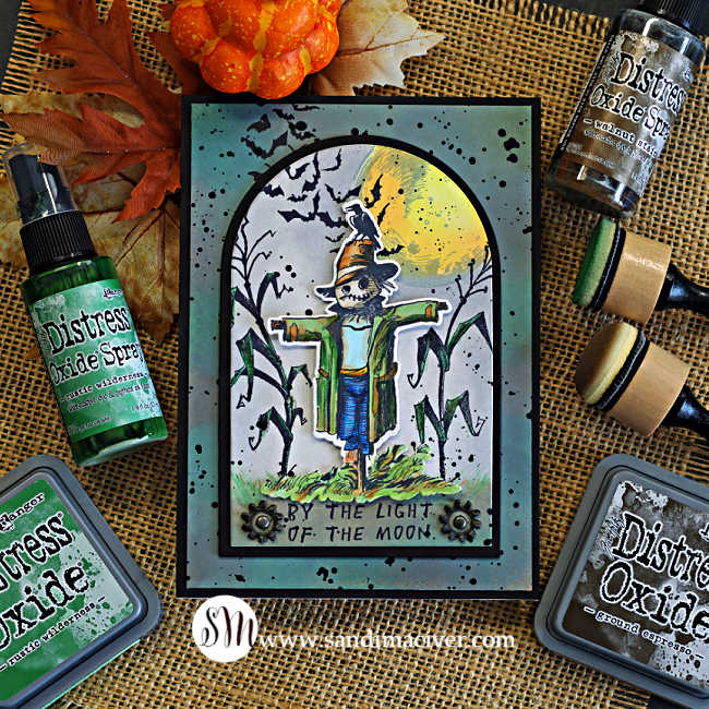 Tim Holtz The Scarecrow Halloween card featuring the new coordinating dies, with a Copic-colored scarecrow layered over a moonlit cornfield, flying bats and Distress ink background.