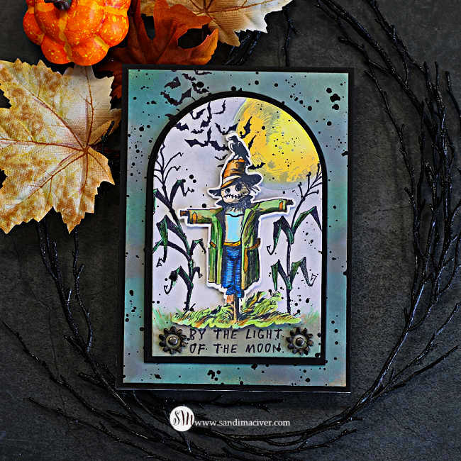 Tim Holtz The Scarecrow Halloween card featuring the new coordinating dies, with a Copic-colored scarecrow layered over a moonlit cornfield, flying bats and Distress ink background.