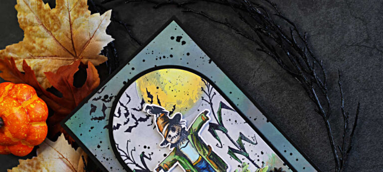 Tim Holtz The Scarecrow Halloween card featuring the new coordinating dies, with a colorful die-cut scarecrow layered over a distressed moonlit cornfield and flying bats.
