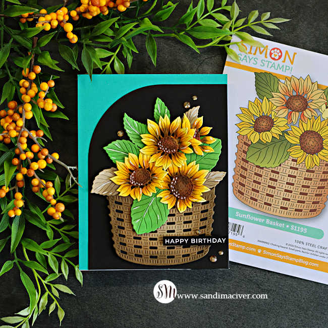 Handmade birthday card featuring golden yellow sunflowers and green leaves in a woven basket, layered over a black Squarevel die-cut mat with a teal card base.