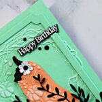 Mint green and coral Harvest Heirloom birthday card featuring an embossed Pumpkin Wreath background, black leafy accents, white flowers, and a framed Happy Birthday sentiment.