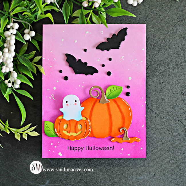 Pink Halloween card featuring a cute ghost peeking from a jack-o’-lantern, a large orange pumpkin, black bats, and a pink ink-blended background with white splatters.