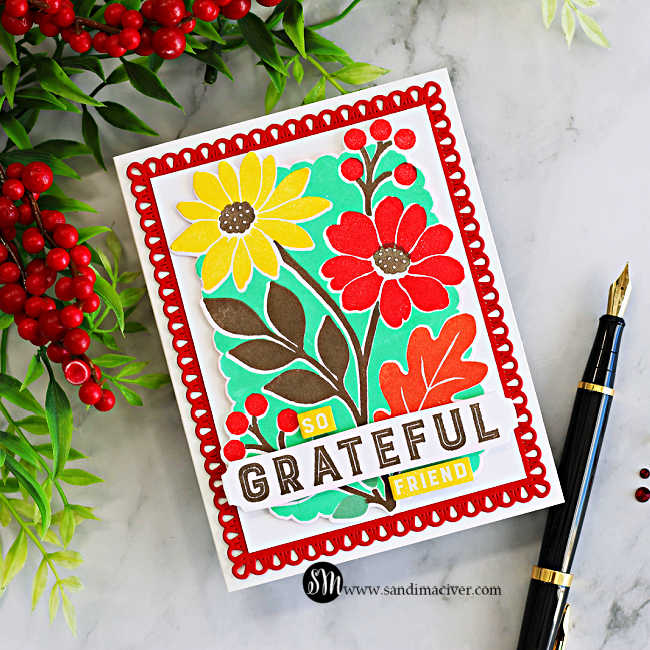 STAMPtember Concord & 9th Incredibly Grateful floral card featuring bright red and yellow flowers, mint green accents, and a decorative red die-cut frame, styled with red berries and a black fountain pen.