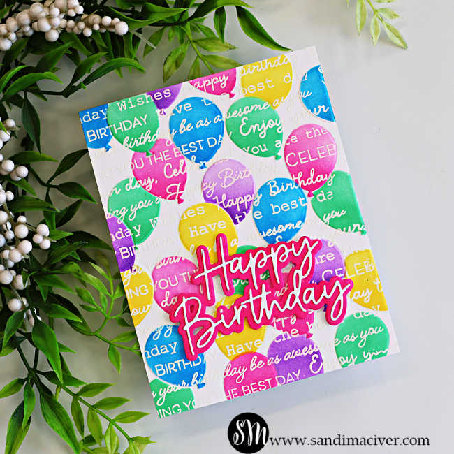 Colorful handmade birthday card featuring embossed balloons in pink, purple, green, yellow, and blue, overlaid with white birthday greetings and a layered pink Happy Birthday sentiment.