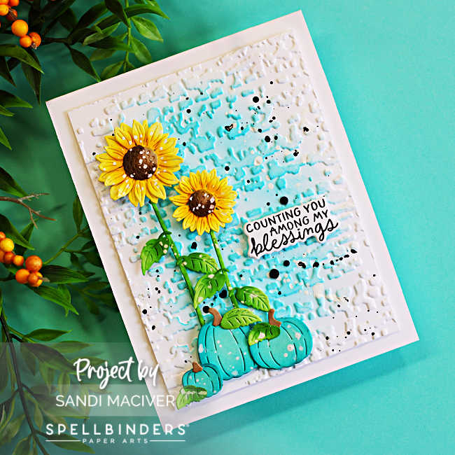 Handmade fall card featuring bright yellow sunflowers and turquoise pumpkins on a textured white background with aqua ink blending and black and white splatters, finished with a “Counting You Among My Blessings” sentiment.