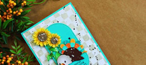 Fun Thanksgiving card featuring a colorful Too Much Turkey die cut, bright sunflowers, turquoise arches, and a stenciled check background with black splatter.