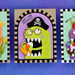Three handmade cards featuring Chompster new accessories: coral Mrs. Chompster with birthday cake, a lime green Halloween pirate with candy corn, and a purple Christmas elf with pudding, each framed by a checkerboard border.