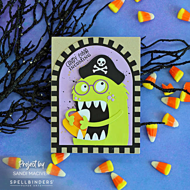 Handmade Snackula Halloween card featuring lime green Chompster in a black pirate hat holding candy corn, with a splattered lavender background, arched kraft-and-black checkerboard border, and “Candy Coma Incoming” sentiment.