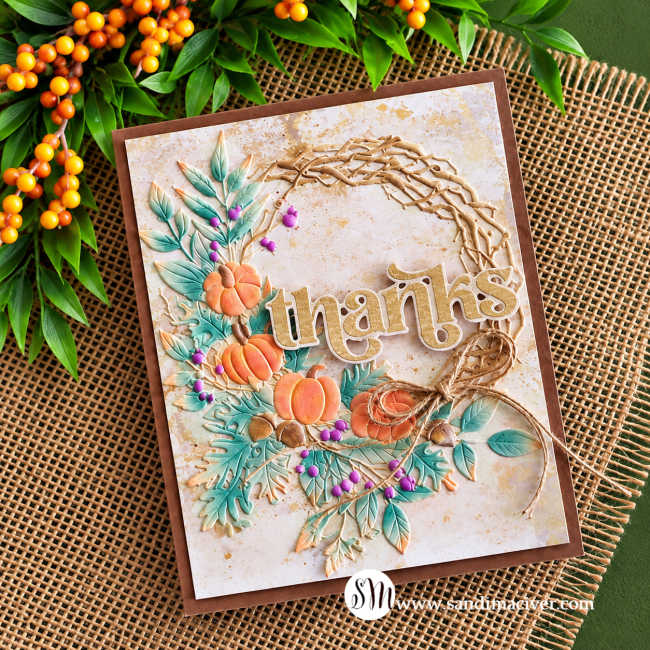 Fall thank-you card featuring Distress Oxide watercolor embossing with pumpkins, teal foliage, purple berries, a twine bow, and a gold “thanks” sentiment.